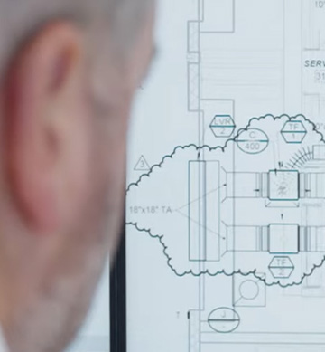 an expert reviewing schematics