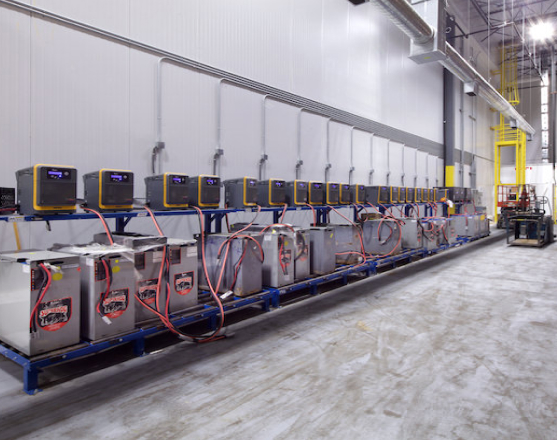 interior of a large warehouse facility showing a wall lined with cold storage equipment